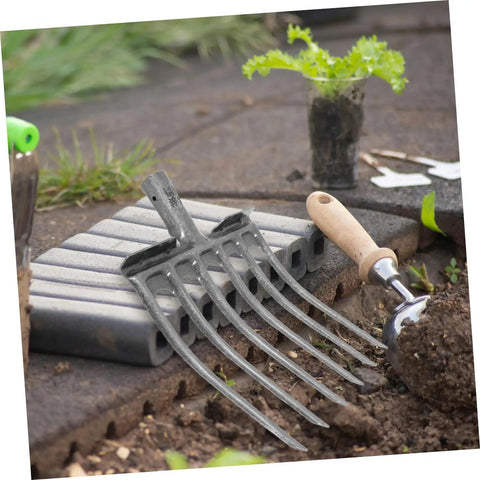 Heavy Duty Steel Garden Fork For Soil Loosening And Planting Area Prep, Rugged Multi Purpose Farm Tool on garden bed