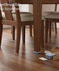 Wooden chair with Heavy Duty PTFE Furniture Sliders With Self Adhesive Floor Protectors on hardwood floor, open box beside.