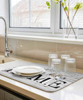 Red Heart Dish Drying Mat with white retro wood grain design on kitchen counter, displaying plates and glasses, super absorbent microfiber