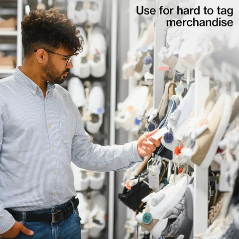 Man examining shoes displayed on a rack, using Heavy Duty Five Inch Clear Adjustable Loop Ties One Thousand Bulk Pack With Beaded Lock Pins.