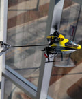 120S2 RC Helicopter BNF With SAFE Technology, Lightweight Carbon Fiber Airframe, flying near window