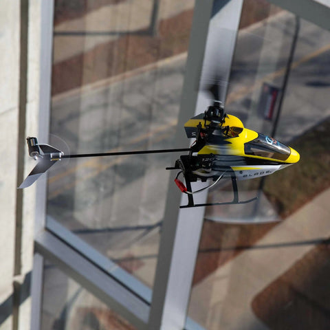 120S2 RC Helicopter BNF With SAFE Technology, Lightweight Carbon Fiber Airframe, flying near window
