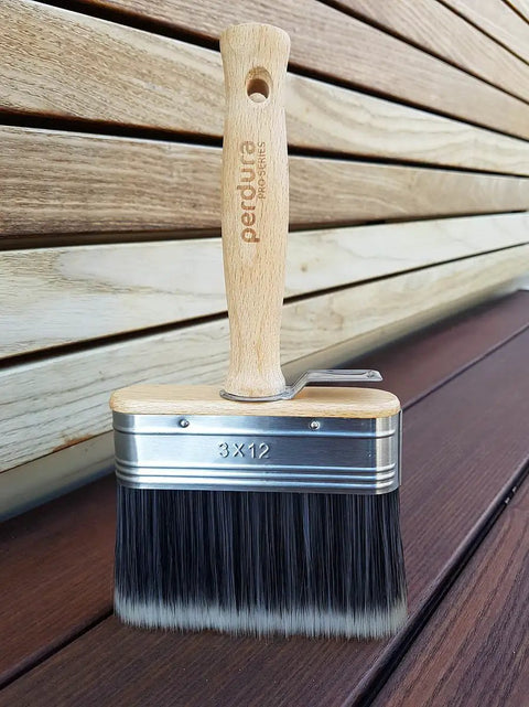 Go To Rapid Stain Deck Brush Applicator 5 Inch with wooden handle placed on wooden deck surface for staining and sealing.