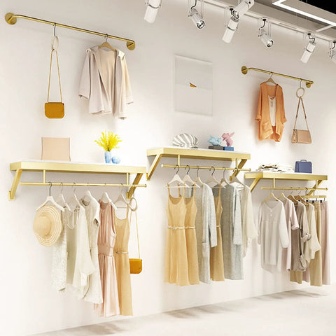 Top Shelf Wall Mounted Clothing Rack System Kit Crafted from Rock Solid Wrought Iron Pipes and Rugged Pine Boards for Boutique or Main Street Closets That Can Take Some Serious Wear and Tear featuring stylish garments and shelves.