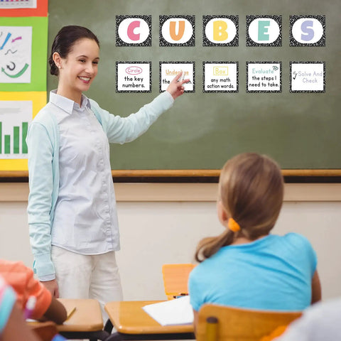 Teacher using 10 Piece Math Bulletin Board Set For Classroom Cubes And Problem Solving Posters in an elementary classroom.