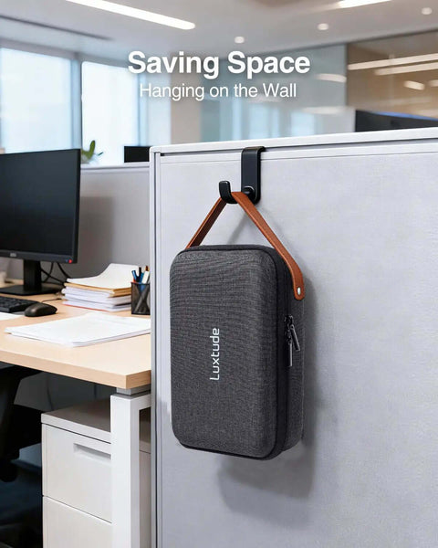The Ultimate Go To Tech Organizer Travel Case For Portable Electronics And Daily Cord Management Featuring A Smooth Leather Handle Compact Fit hanging on an office wall.
