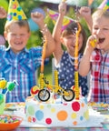 Kids at a birthday party with 12 Pack Mini Finger BMX Bikes For Kids And Adults, Reconfigurable Tiny Bicycle Toys, on a cake.