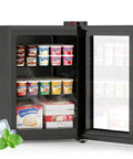 Space Savvy 2.4 Cu Ft Mini Freezer With Clear Glass Front Door showcasing ice cream and desserts on removable shelves.