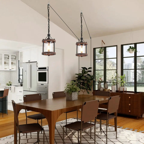 Cozy Farmhouse Style Plug In Pendant Light With Rustic Wood And Glass Cylinder illuminating kitchen island, industrial bronze finish.