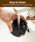 Ninja ES601 Coffee Tamper Base With Portafilter Stand Silicone Tamper Holder being rinsed under a faucet for easy cleaning.