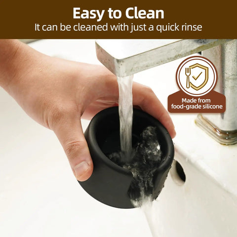 Ninja ES601 Coffee Tamper Base With Portafilter Stand Silicone Tamper Holder being rinsed under a faucet for easy cleaning.
