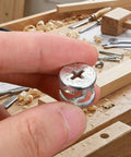 Hand holding a Hardcore Zinc Alloy Cam Lock Fastener, 15 mm OD, for cabinetry and drawer assembly.