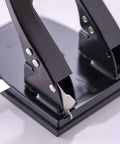 Close-up of the Workhorse Two Hole Puncher for Paper with 30 Sheet Capacity Adjustable Guide and Locking Mechanism