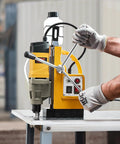 Get Ready To Hammer Metal With This Badass 1450W Magnetic Drill Press, shown in use for precise drilling on steel.