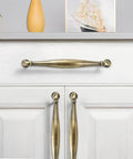 Two Pack 4 Inch Hole-Center Antique English Brass Drawer Pulls Cabinet Handles on white cabinet door