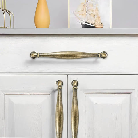 Two Pack 4 Inch Hole-Center Antique English Brass Drawer Pulls Cabinet Handles on white cabinet door