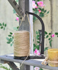 Cast Iron Twine Holder Set With 1300ft Natural Jute Twine, Rope Rack And Scissors, Antique Sewing Machine Style, Black Finish, shown in garden setting