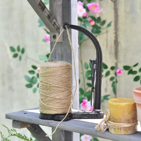 Cast Iron Twine Holder Set With 1300ft Natural Jute Twine, Rope Rack And Scissors, Antique Sewing Machine Style, Black Finish, shown in garden setting