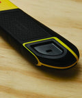 Close-up of black and yellow FatMax Snap Off Knife durable utility knife with ergonomic grip on wood surface.