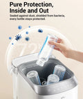 Front view of Bear Bottle Washer Pro; white/silver baby bottle sterilizer and dryer with bottle being inserted.