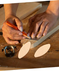 Hands marking measurements on wood for 100 Pack Hella Strong Beech Wood Joiner Biscuits For Heavy Duty Woodworking.