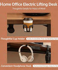 Electric Height Adjustable Standing Desk With Memory Controller And Anti Collision Guard Zero Hassle Adjustment Badass Durable Gaming Table For Home Office Ergonomic Setup 27 By 55 Inches featuring cup holder and headphone hook details.