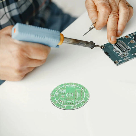 Hands using soldering iron on DIY electronics board, Beginner Soldering Practice Kit, 4 Pack DIY Electronics Training Boards for Realistic Welding Skills.