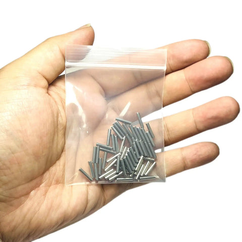 Built Tough Precision Ground 2mm X 10mm Dowel Pins 60 Pack in hand, showcasing stainless steel cylinder rods for wood projects.