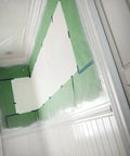 Green Premium General Purpose Masking Paper For Pros preventing overspray on walls and ceiling during paint job.