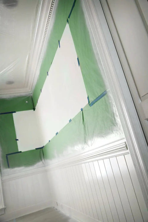 Green Premium General Purpose Masking Paper For Pros preventing overspray on walls and ceiling during paint job.