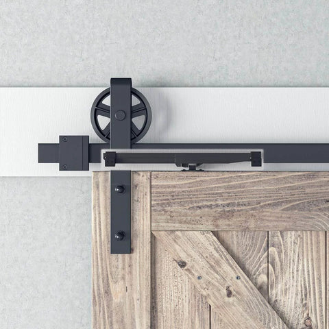 Invisible Black Barn Door Soft Close Kit installed on wooden door with seamless behind track look