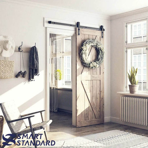 Heavy Duty Sliding Barn Door Hardware Kit For 30 Inch Wide Door Panel Black Finish With J Shape Hangers installed in living room