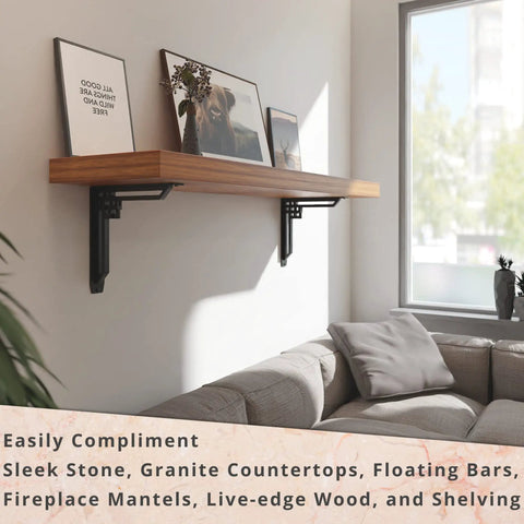 Heavy Duty Shelf Brackets 2 Pack, Tough As Nails Designer Metal Corbels For Mantels, Countertops And Decorative Shelving, 12 X 12 X 2 Inches, Black Wrought Iron Finish, Handles Over 500 Lb Per Pair, Built From American Steel supporting a wooden shelf above a sofa in a living room.