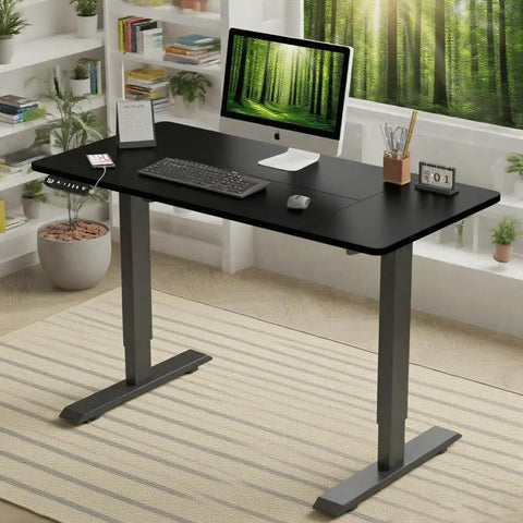 Rock Solid 55 Inch Electric Standing Desk With Double Beam Frame for Home Office or Gaming Setup in black with keyboard and monitor.