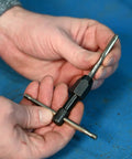 Hand holding T-Handle Tap Wrench For Quarter To Half Inch Taps Steel Construction Precise Control Easy Install And Firm Grip