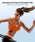 Woman running with 8GB Clip MP3 Player With FM Radio Shuffle Sweatproof Silicone Case clipped on orange top