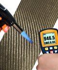 Built Tough 26X48 Inch Reinforced Exhaust Heat Shield Mat With Peel And Stick Adhesive Backing shown being tested with a torch and thermometer.