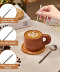 All-In-One 58mm Espresso Accessories Kit With Spring-Loaded Calibrated Tamper shown with latte art pen in coffee