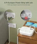 Six Foot European Travel Power Strip With Three US Outlets And Three USB Ports, US To Europe Plug Adapter, White on desk