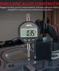 Pro Grade Digital Dial Indicator 1 Inch With 0.0005 Inch Resolution, LCD Readout in industrial setting, zinc alloy body.