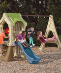 Kids playing on Tot Friendly Outdoor Kids Playset With Two Tier Swing Set, Slide, Climber, Crawl Space And Playhouse.
