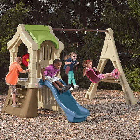 Kids playing on Tot Friendly Outdoor Kids Playset With Two Tier Swing Set, Slide, Climber, Crawl Space And Playhouse.