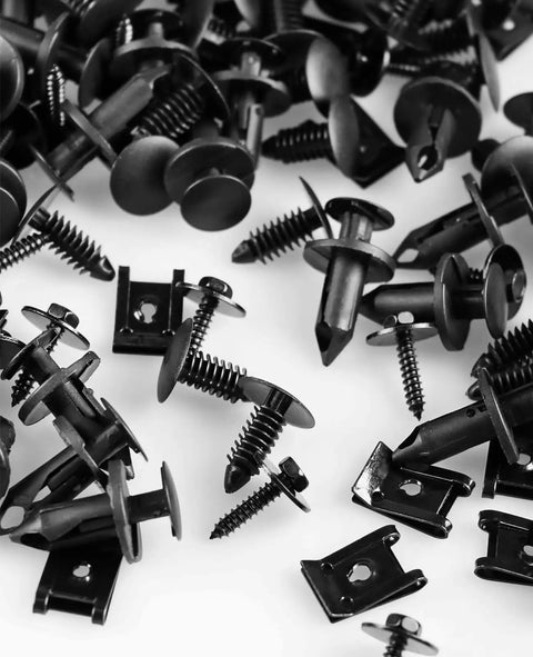 Assorted components from 120 Go-To M4.2 Universal Fender Liner Kit with hex head screws, U nuts, nylon bumper fasteners, plastic clips visible