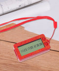 Red handheld device for generating random numbers, shown on a wooden table with a clear digital display.