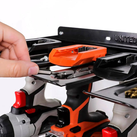 Close-up of wall mounted drill storage rack for four drills and accessories, keeps cords tidy with anti slip dish trays