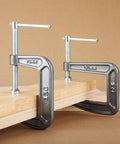 Heavy Duty C Clamp For Home, Garage, And Shop Use, Steel Construction gripping wooden boards on a workbench for woodworking projects.