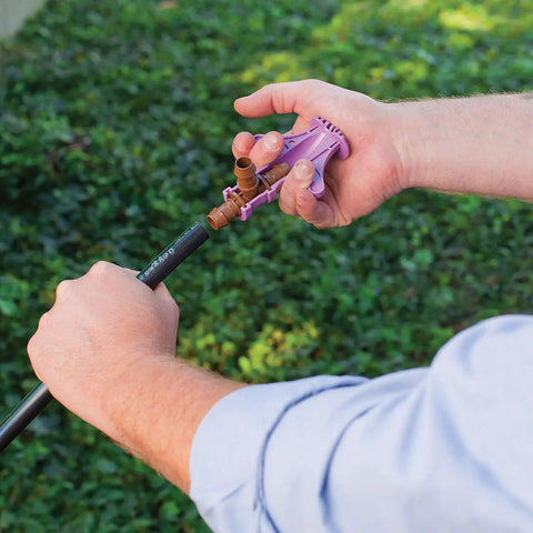 Drip Irrigation Barbed Fitting Insertion Tool For One Half Inch Tubing, Easy Full Insertion And Secure Locking in use outdoors