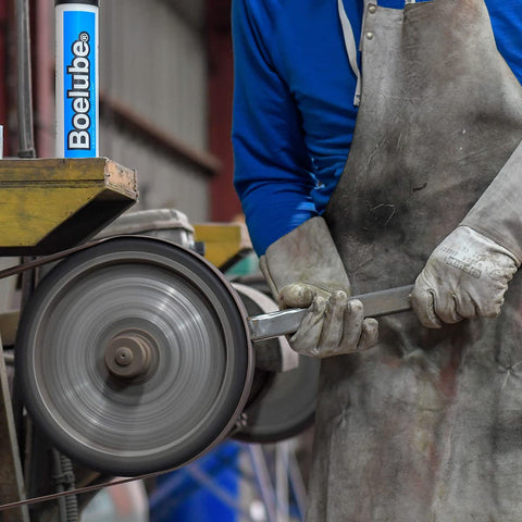 Worker using Go-To Solid Industrial Lubricant For Minimum Quantity Lubrication MQL Push Tube in metalworking shop