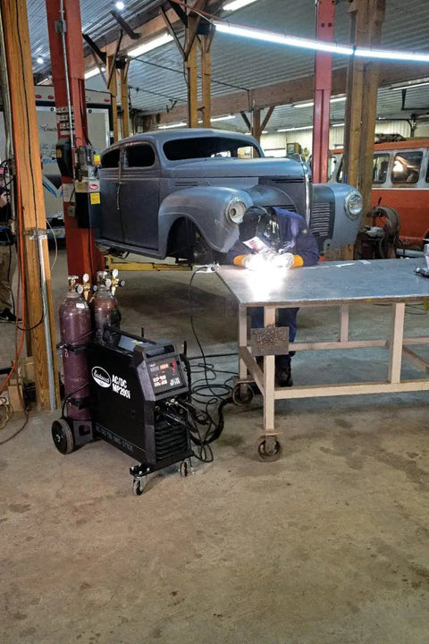 Welder using Elite 200 Amp All In One Multi Process AC DC Welder MP200i on metal sheet in workshop