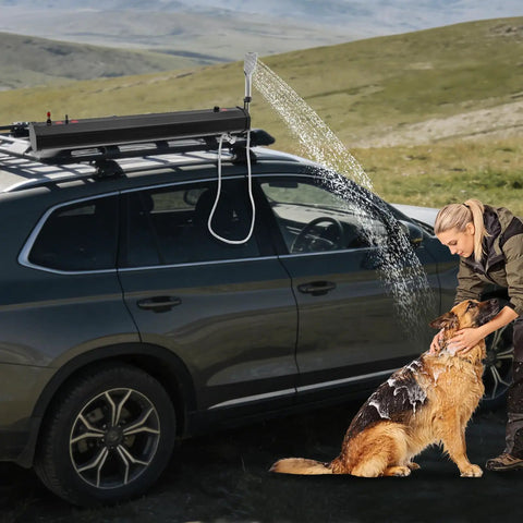 Woman washing dog with Portable Road Shower For Camping And Outdoors, 5.3 Gallon Pressurized Water Tank attached to car